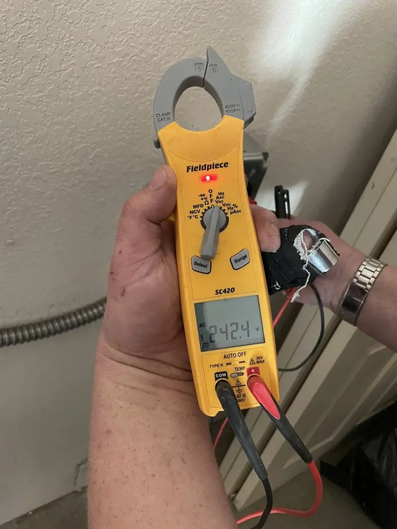 Voltage testing with clamp meter during Recessed Lighting Installation in Idaho Falls